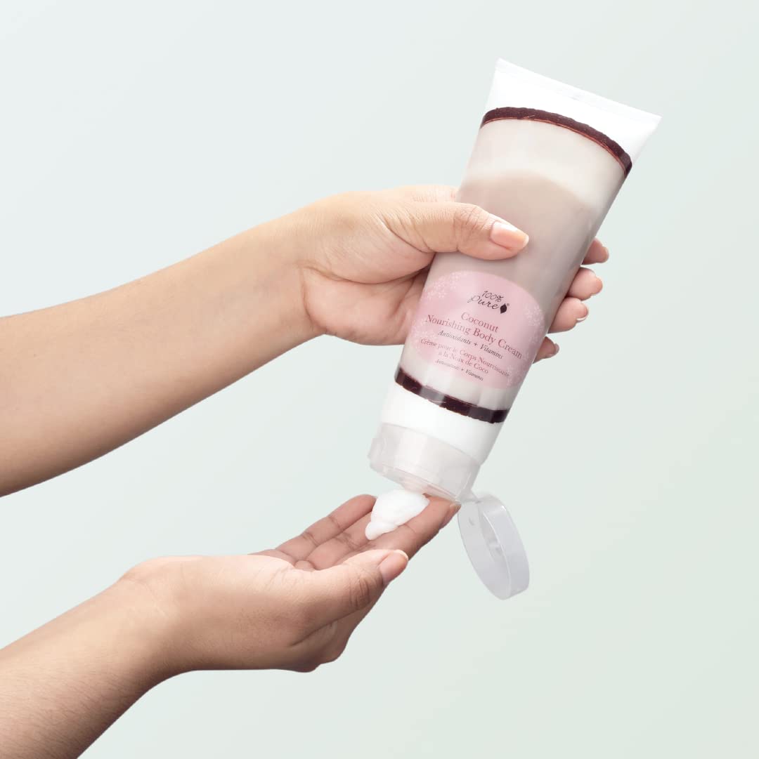 Applying 100% PURE coconut lotion on hand for daily moisturization.