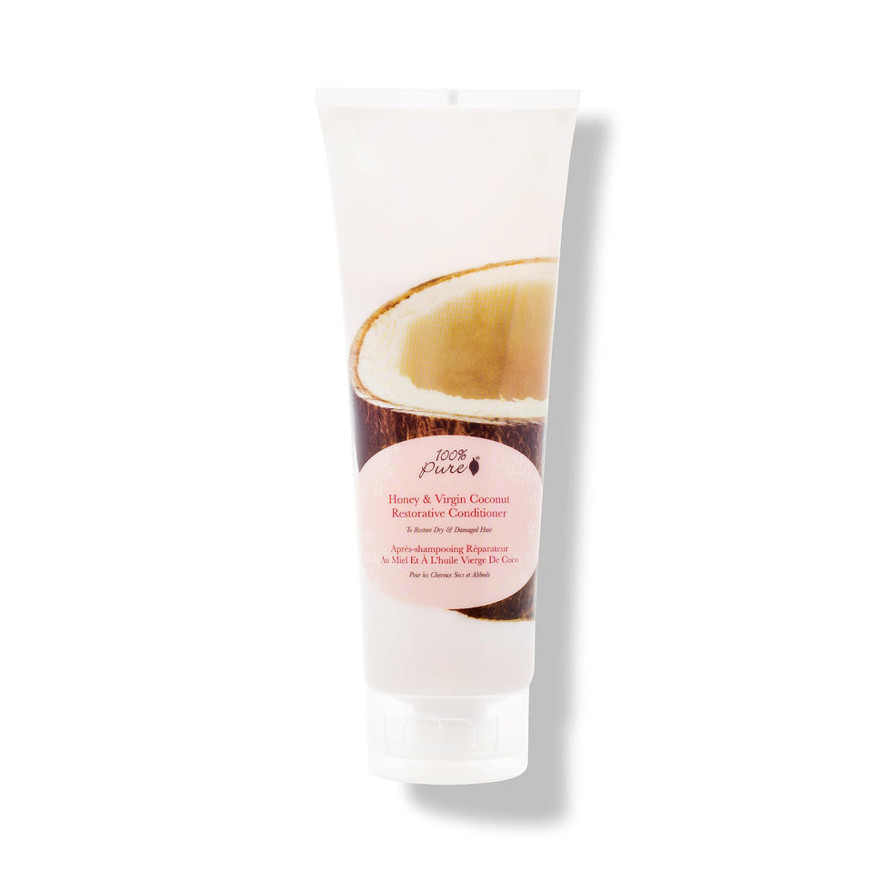 100% PURE Honey & Coconut Restorative Conditioner bottle closeup for hydrated, smooth hair.
