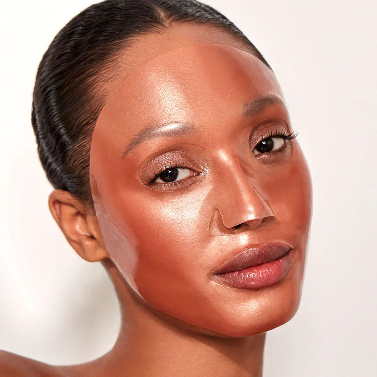 111SKIN hydrogel mask texture with 24k gold and Damask rose for soothing radiance.
