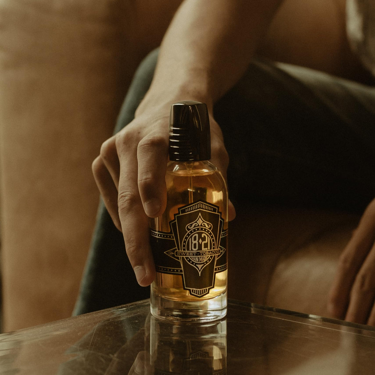 18.21 Man Made Sweet Tobacco glass bottle on dresser conveys timeless elegance and all-day fragrance.