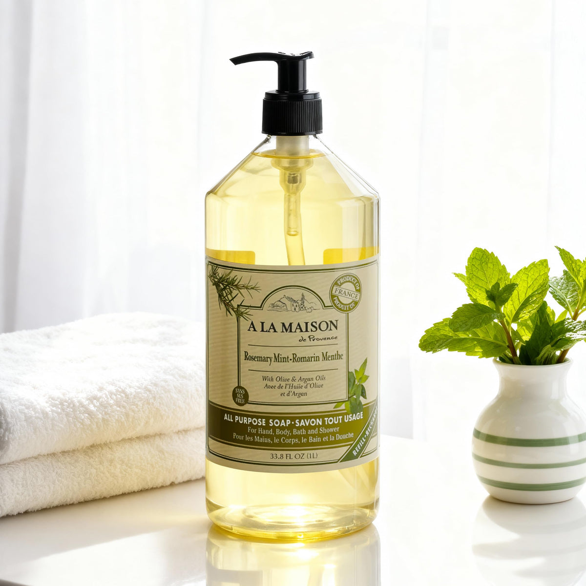 Provence-style bathroom scene with A La Maison soap bottle.