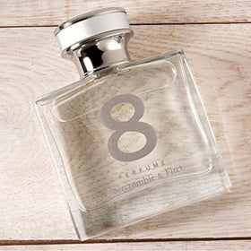 Cap detail of Abercrombie & Fitch perfume highlighting sleek design.