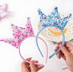 Acshio child wearing princess crown headband during party