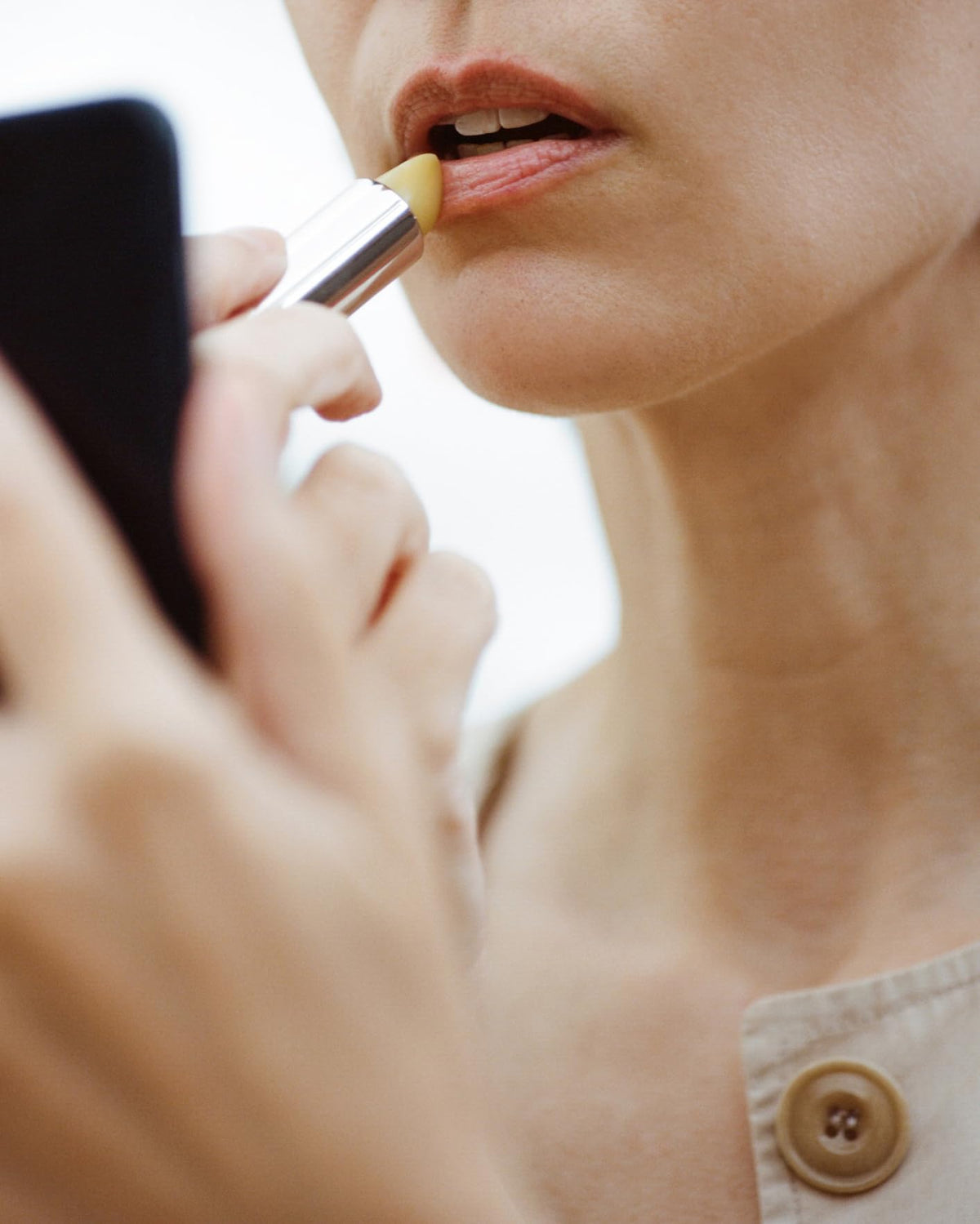 Creamy texture of ACTIVIST lip balm ready for smooth application.