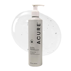 Acure Bonding Shampoo bottle on counter for daily cleansing of dry hair.