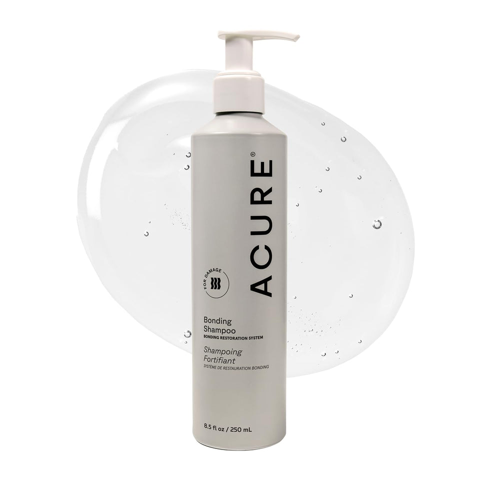 Acure Bonding Shampoo bottle on counter for daily cleansing of dry hair.