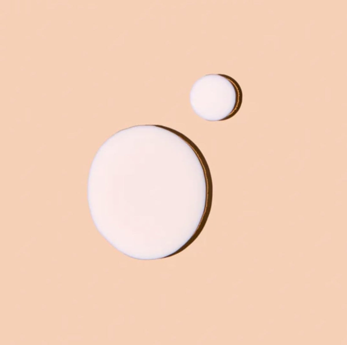 Applying Acure Sun Serum Drops SPF 30 under makeup for glow.