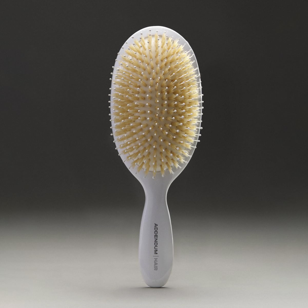 Addendum Hair boar bristle detangler close-up illustrates gentle glide