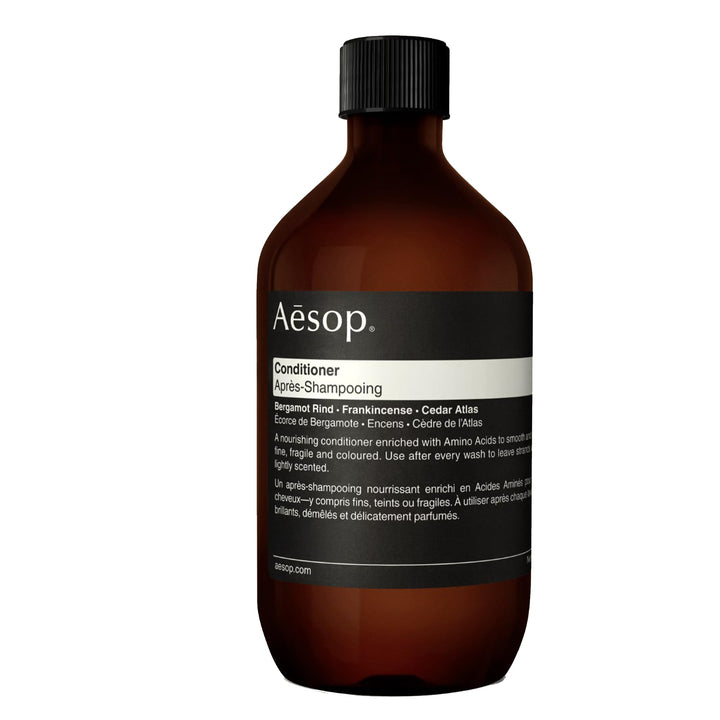 Aesop conditioner refill bottle pouring into hand for hydration