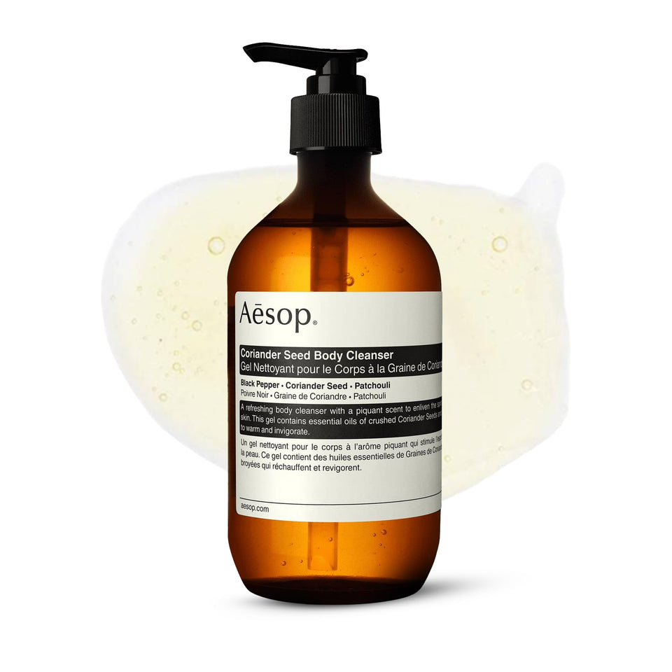 Aesop Coriander Seed Body Cleanser bottle pouring, showcasing a warm, spicy aroma.