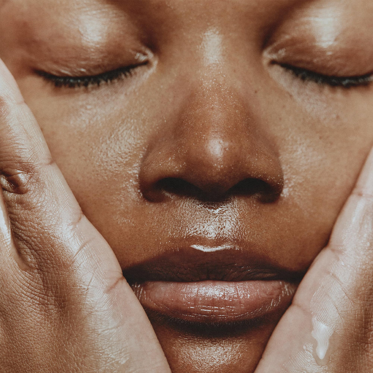 Aesop Fabulous Face Cleanser hands massaging the cleanser onto skin.