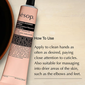 Gift-ready Aesop hand balm set on decorative surface for thoughtful gifting.