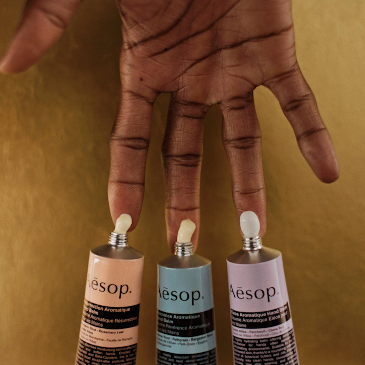 Aesop hand balm travel-size trio arranged on a tray for on-the-go hydration.