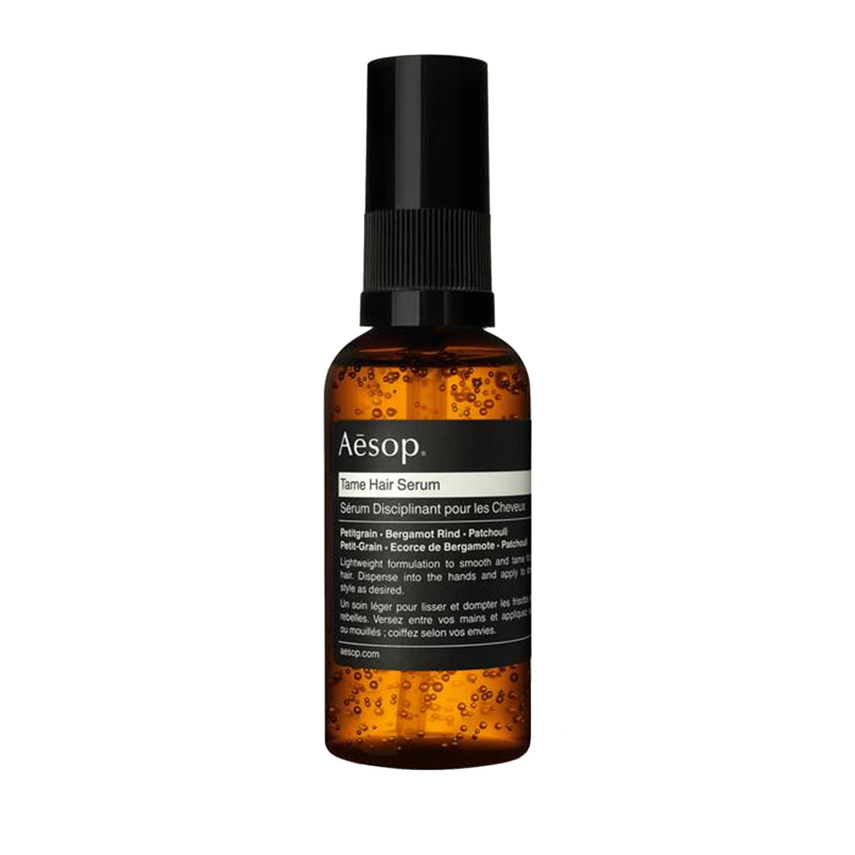 Aesop Tame Hair Serum bottle smoothing flyaways for a sleek look.