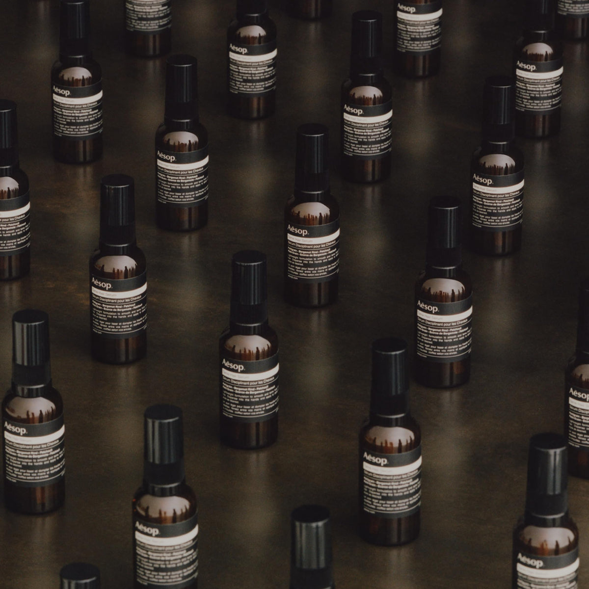 Aesop Tame Hair Serum applied to damp hair for styling.