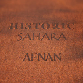 Afnan Historic Sahara sunlit shot, warm spice glow with desert-inspired mood.