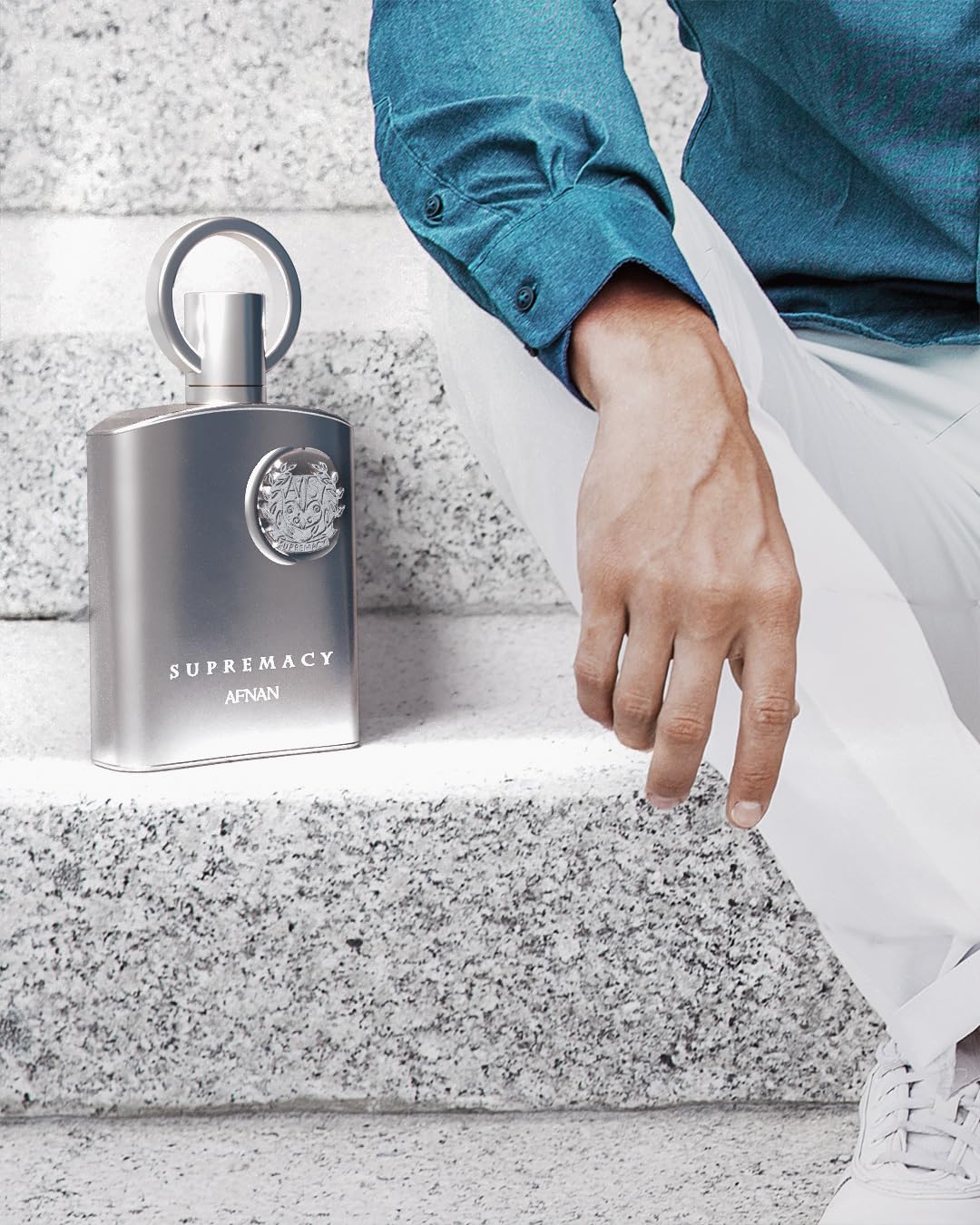Afnan Supremacy Pour Homme glossy surface reflects modern masculine fragrance energy