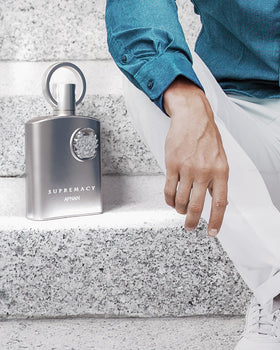 Afnan Supremacy Pour Homme glossy surface reflects modern masculine fragrance energy