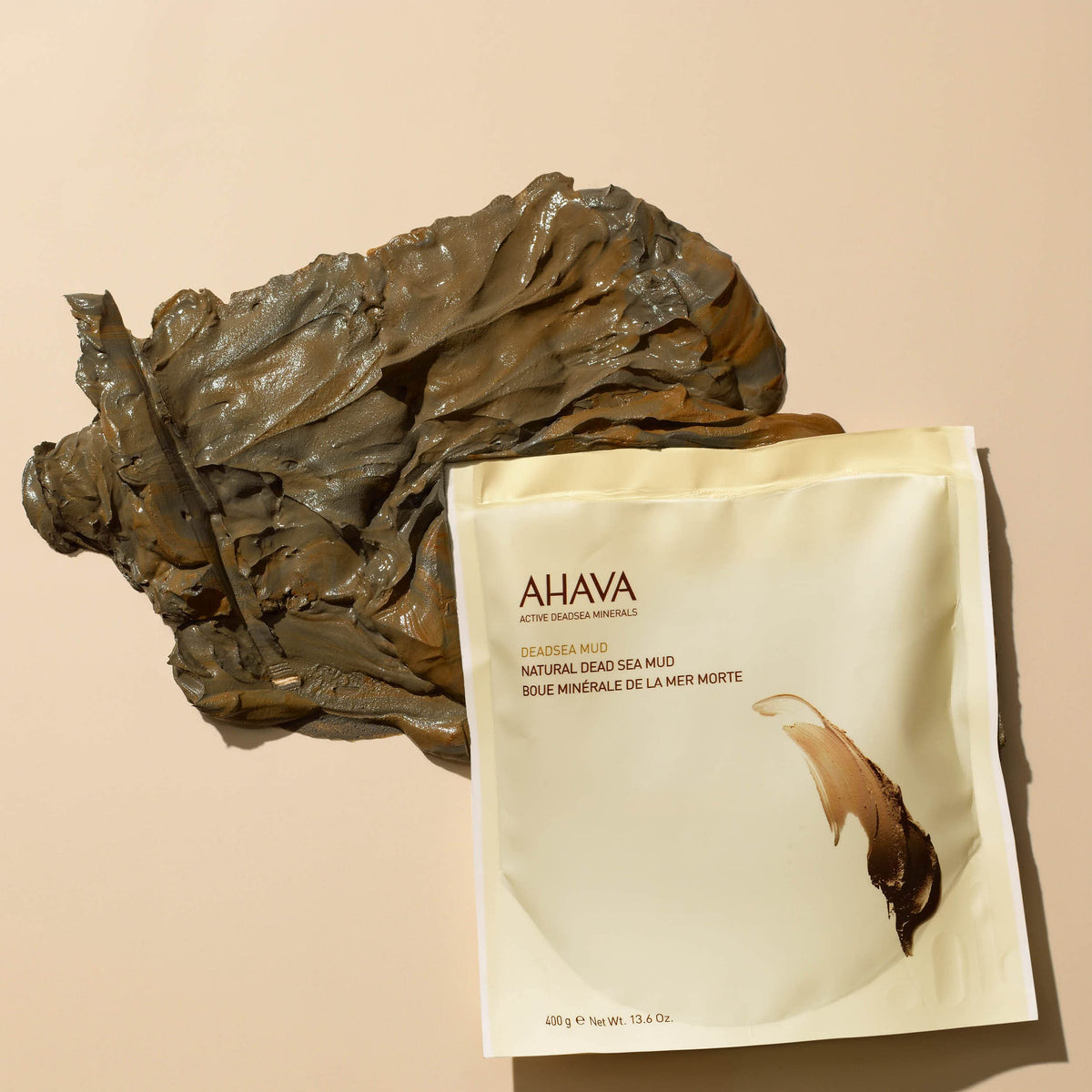 AHAVA creamy black mud being spread for cleansing and relaxation