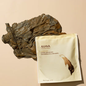 AHAVA creamy black mud being spread for cleansing and relaxation