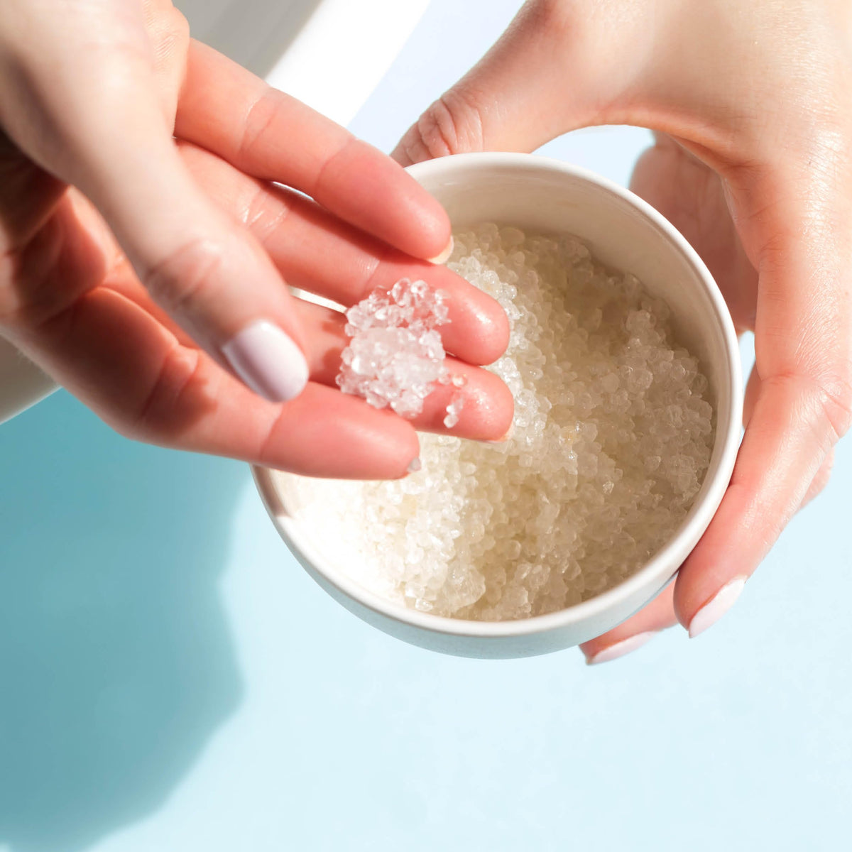 Close-up of minerals in AHAVA Dead Sea Bath Salt for intensified skin hydration.