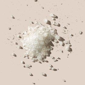 AHAVA Dead Sea Mineral Bath Salt in a bowl for a soothing home spa ritual.
