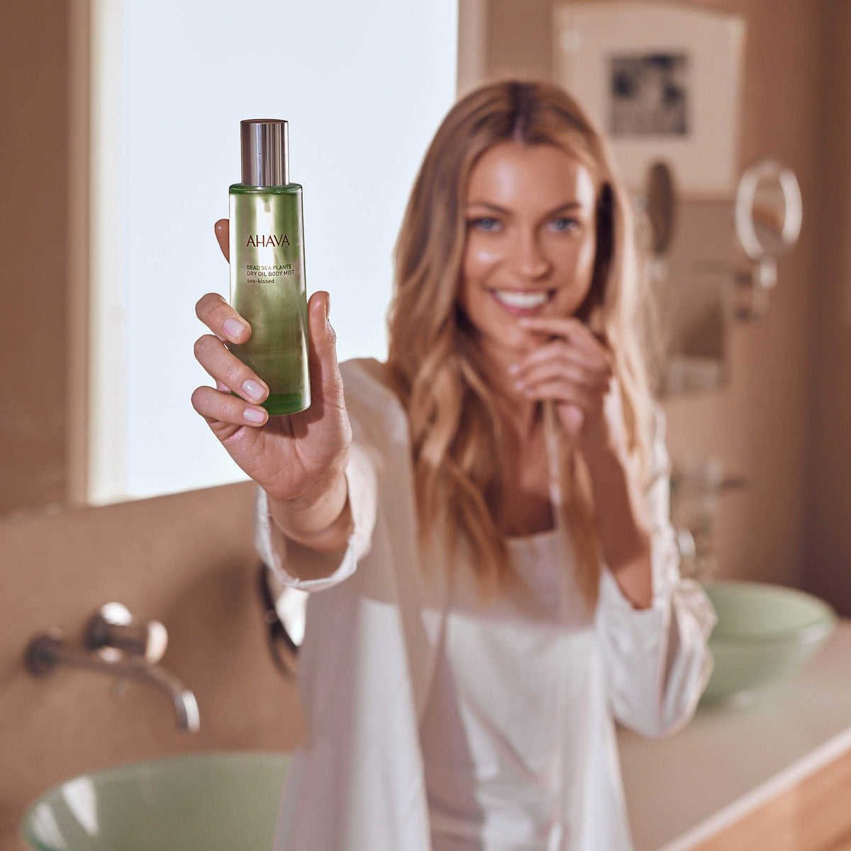 AHAVA Dry Oil Body Mist highlights jojoba seed oil for nourished skin.