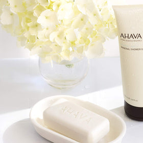 AHAVA soapless cleanser dual-action bar demonstrates cleansing and conditioning.