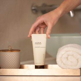AHAVA cleansing gel in action removing makeup gently from cheeks.