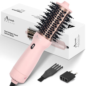 Aima Beauty travel hair dryer brush in pink with an oval barrel for smooth styling.