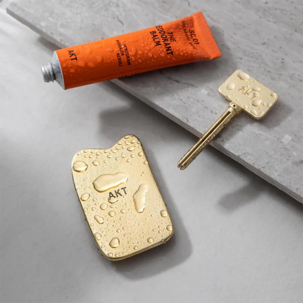 AKT applicator gliding over underarms for even balm distribution.