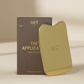 AKT pre-show ritual with gua sha-inspired applicator.