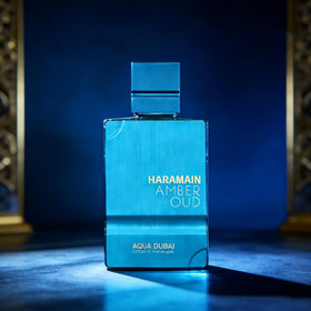 Al Haramain Amber Oud Aqua Dubai bottle resting in velvet display tray for luxury presentation.