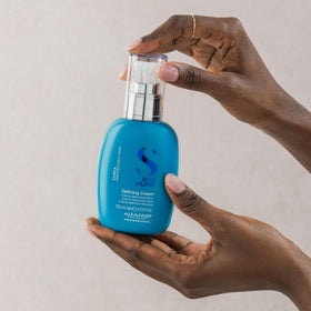 Applying curl defining cream on curls for defined, frizz-controlled style