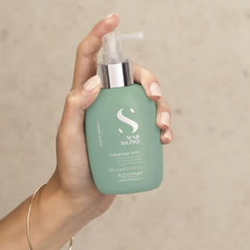 Alfaparf Milano Semi di Lino Scalp Renew tonic pump in use for easy scalp application.