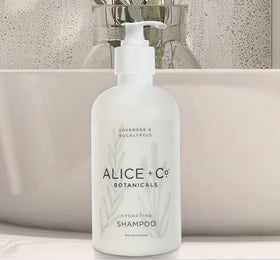 Alice + Co. two bottles on a bathroom sink.