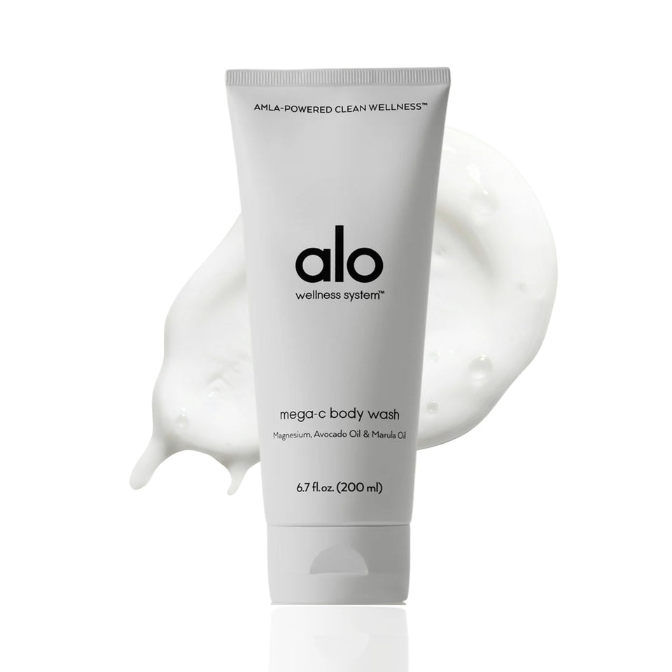 Alo Mega-C Body Wash bottle pouring with citrus scent for refreshing cleanse.