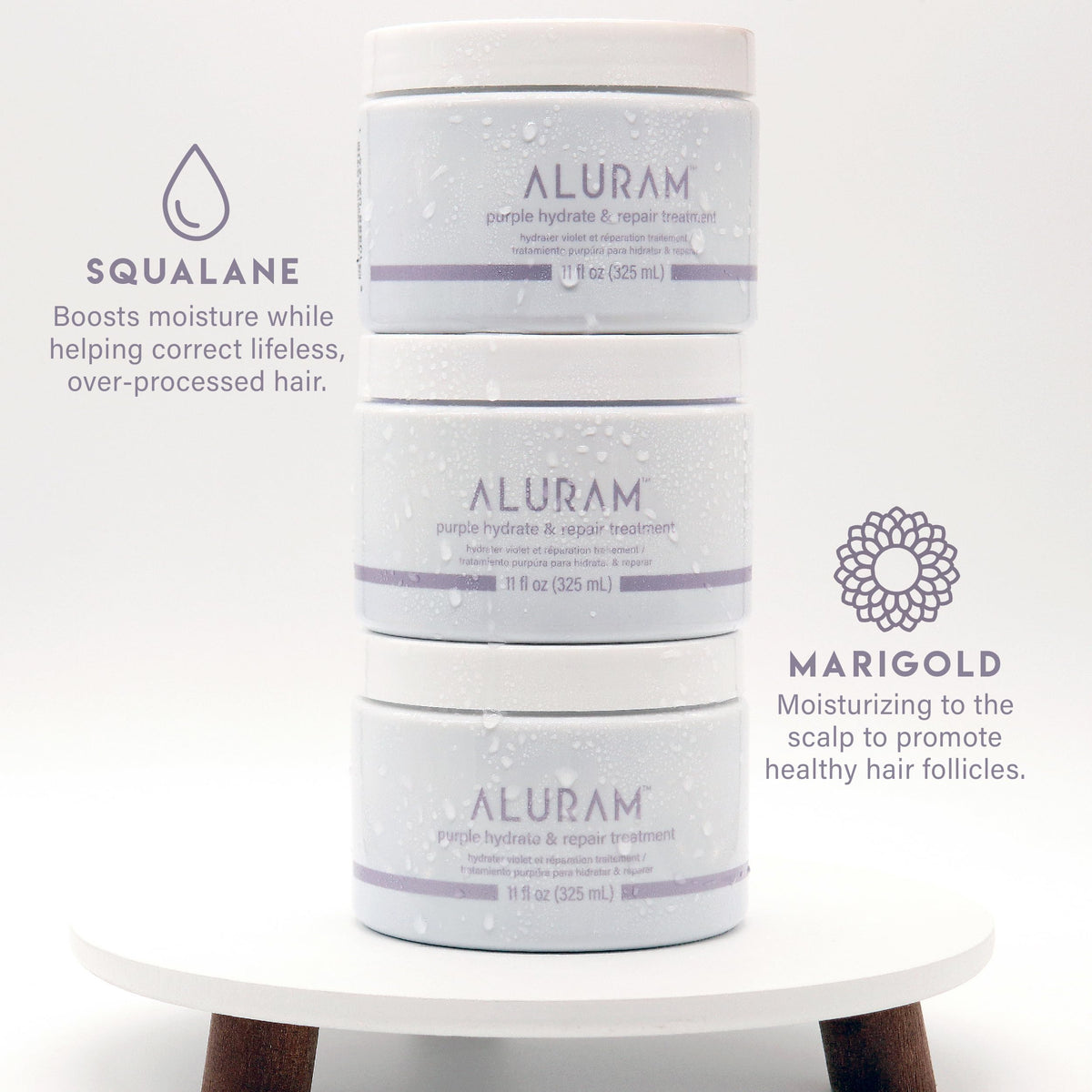 ALURAM Purple Hydrate & Repair bottle beside marula oil and squalane for nourishing hydration.