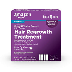 Amazon Basic Care minoxidil 5% foam bottle close-up for targeted crown-area application.