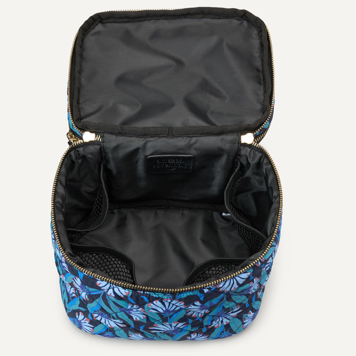 Close-up of brush storage pockets inside the case for tidy organizing.