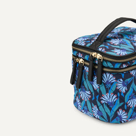 Open top view showing top brush storage area in the blue floral quilted case.