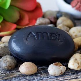 Ambi black soap promoting nourished, soft skin results.