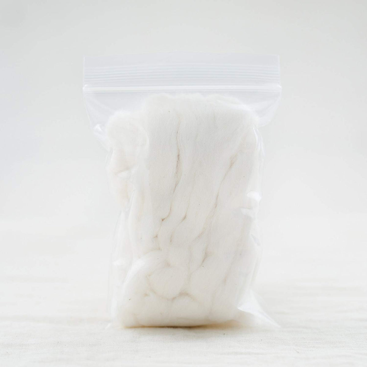 AMOZA organic cotton sliver 13ft pack in hand demonstrates generous quantity for larger projects
