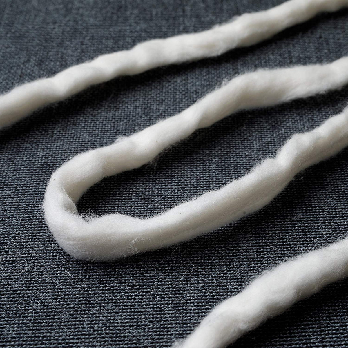 AMOZA unbleached cotton sliver detail highlights subtle natural color and tiny specks
