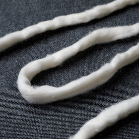 AMOZA unbleached cotton sliver detail highlights subtle natural color and tiny specks
