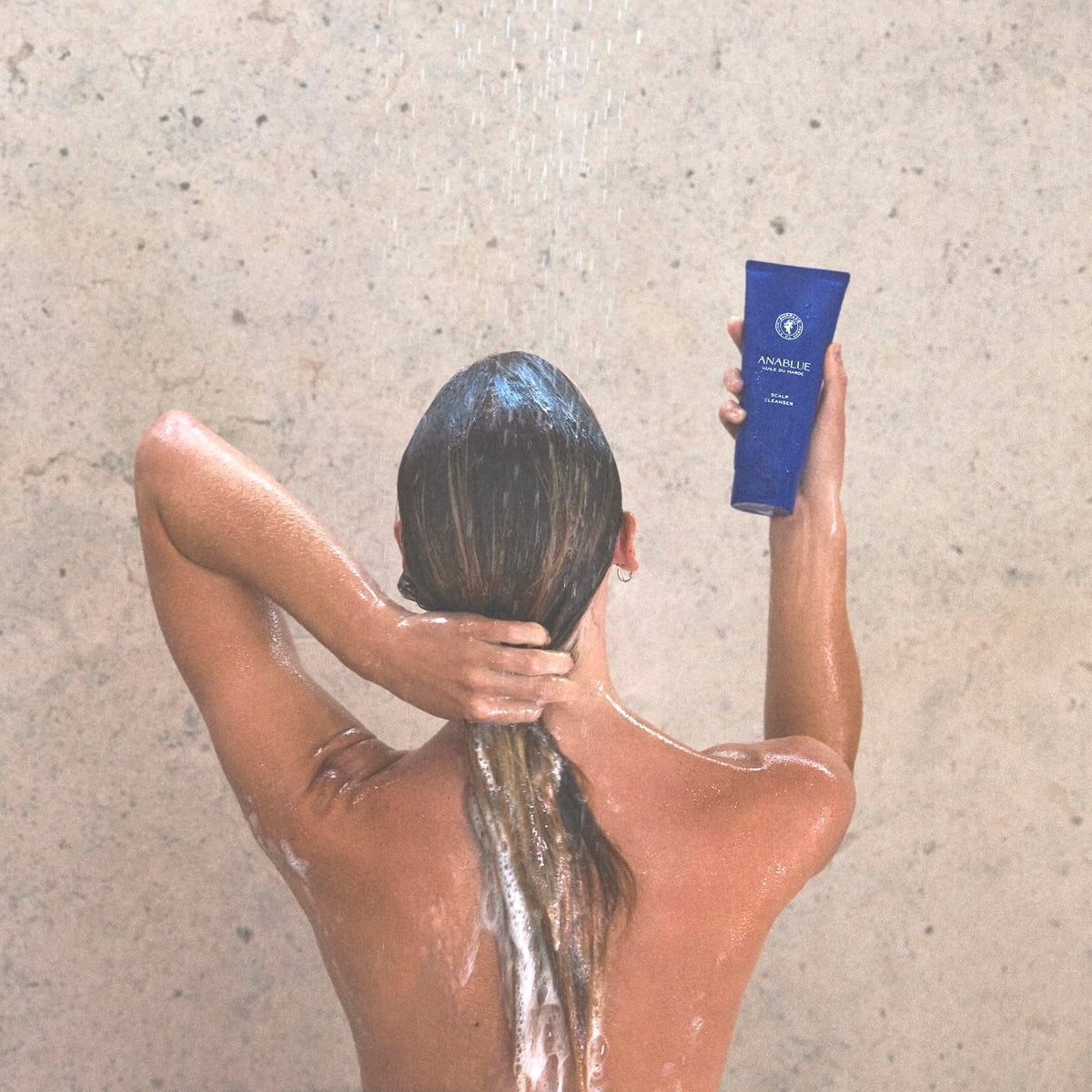 Anablue Scalp Cleanser application shows a scalp massage for thorough cleansing.