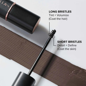 Applicator close-up applying Granite tint to brows for fuller definition.