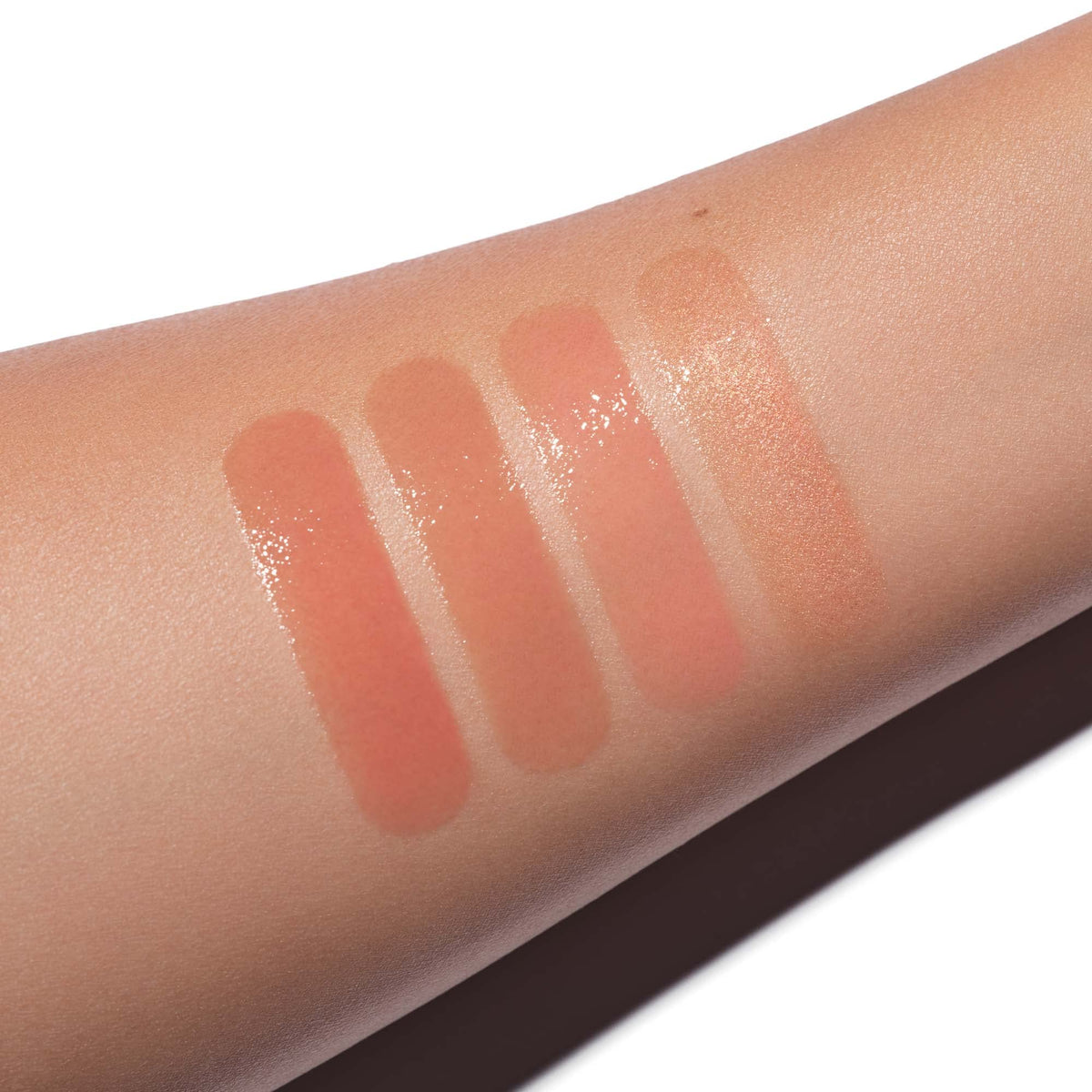 Model wearing Anastasia Beverly Hills Lip Gloss Sun Baked for dimensional glow