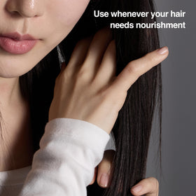 Close-up of ANAZE serum label highlighting natural proteins and oils for nourishment.