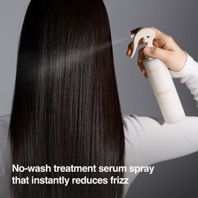 ANAZE Leave-In Collagen Serum spray application on frizzy hair for smoother strands.